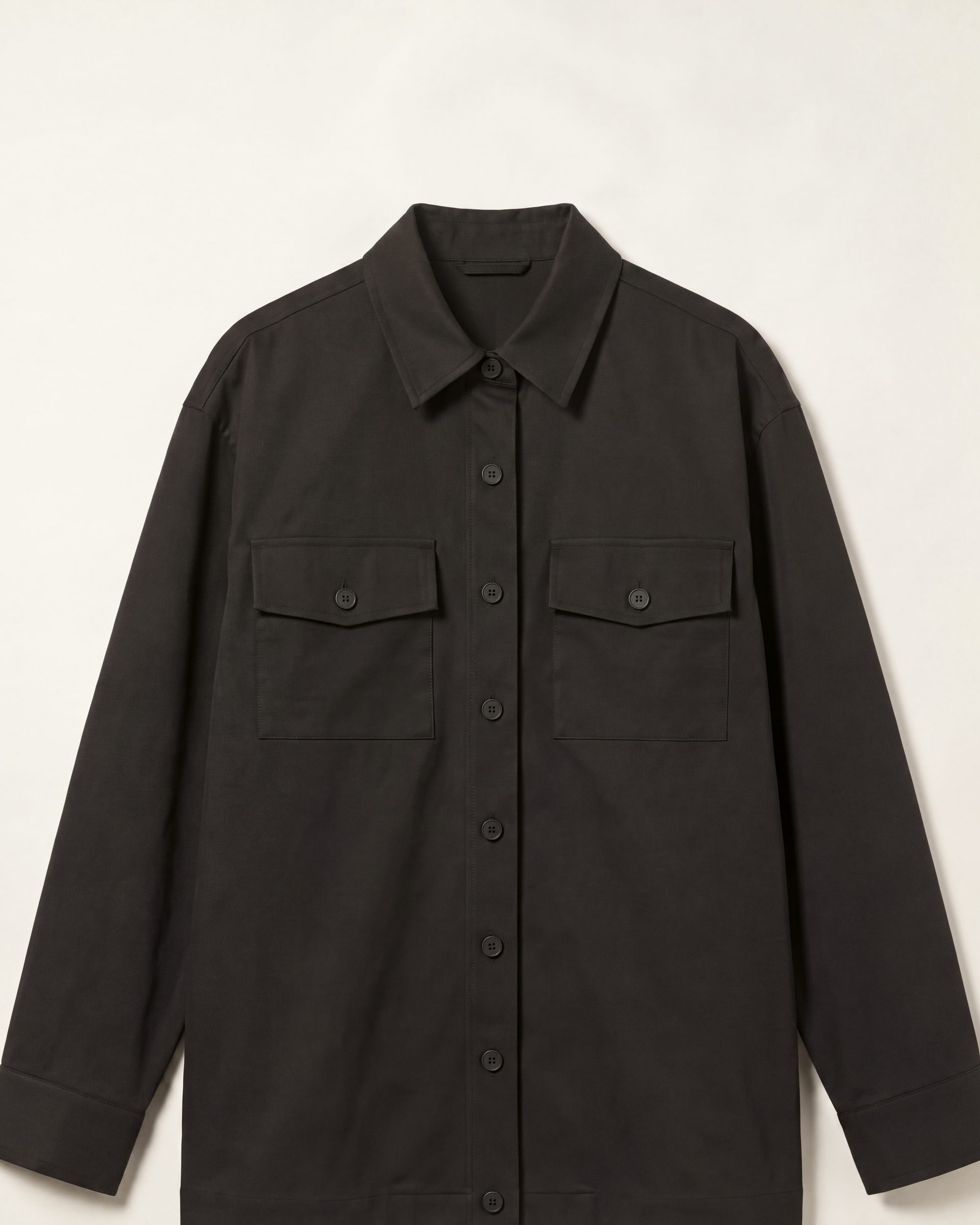 Flat product photograph of a black overshirt